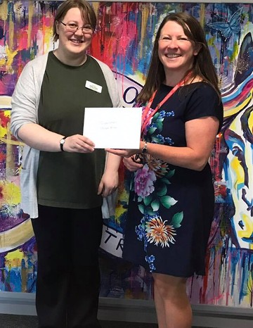 Here is Kathryn, a Senior Library Assistant, presenting a cheque for £150 to Sarah earlier this month.